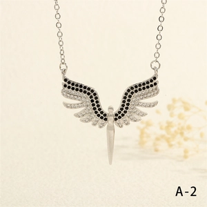 Detailed close-up of angel wing necklace pendant with pave-set zircon stones on O-chain