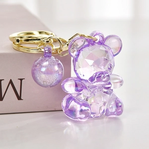 Purple transparent acrylic teddy bear keychain with faceted surface and matching ball charm