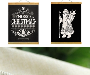 Detail of Christmas wooden scroll wall art featuring Santa and festive typography
