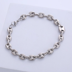 Macro detail of silver stainless steel coffee bean chain link bracelet with lobster clasp
