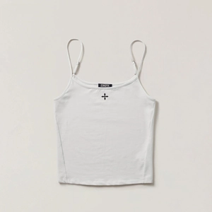 Close-up of white cotton camisole featuring a black cross print and fine shoulder straps
