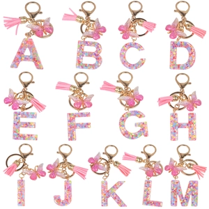 Set of resin initial keychains A-M with colorful sequins, pink tassels and butterflies