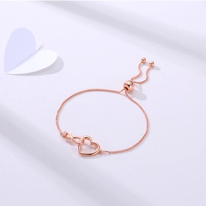 Detail of rose gold infinity heart bracelet with cubic zirconia and adjustable slide clasp