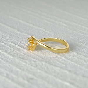 Detail view of S925 sterling silver stamp and sparkling floral cluster stones on gold ring