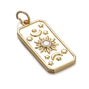 Detail of a rectangular gold sun moon pendant with clear zircon inlay and star patterns