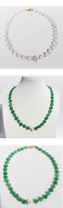 Detailed view of colorful heart stone necklaces with baroque pearls and gold beads