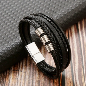 Detail of multi-layer black braided leather bracelet with silver beads and magnetic clasp