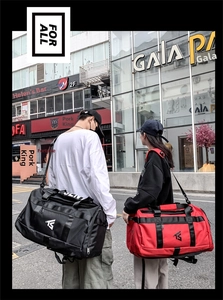 Black and red oxford duffel bags shown on male and female models in urban street setting
