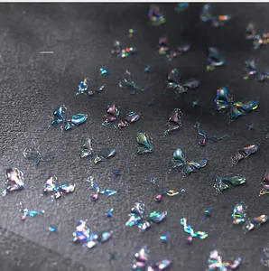 Macro shot of 3D holographic butterfly nail art stickers with embossed aurora metallic finish