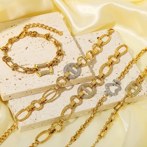 Detailed view of gold and silver plated bracelets with micro-pave cubic zirconia on marble