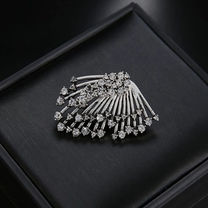 Asymmetric silver leaf stud earrings with sparkling rhinestones in a fanned design