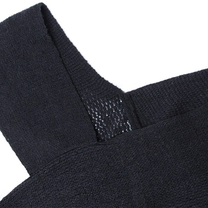 Close-up detail of knitted fabric texture and crisscross shoulder strap design