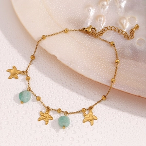 Detail of 18K gold star starfish anklet with turquoise amazonite beads on shell