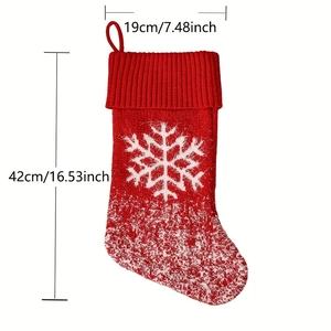 Red knitted Christmas stocking with white snowflake patterns and detailed size dimensions