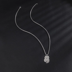 Cute minimalist silver cat pendant necklace made of stainless steel on dark leather background