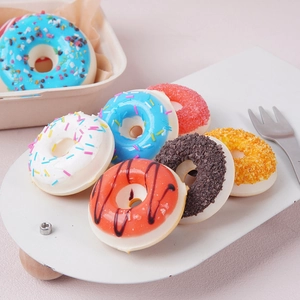 Seven assorted colorful PU faux donuts with realistic sugar sprinkles on a white tray