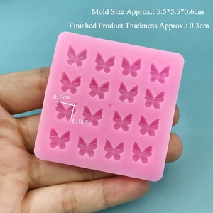 Detailed view of pink silicone mold with 16 butterfly cavities for DIY nail art and resin