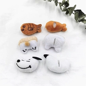 Detailed view of plush cartoon charms including corgi butt and snoopy-style designs