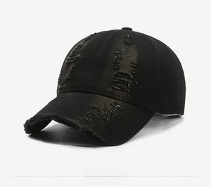 Detail shot of distressed black washed denim baseball cap with street style ripped texture