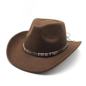 Detailed view of dark brown felt cowboy hat with vintage metal gear and braided band
