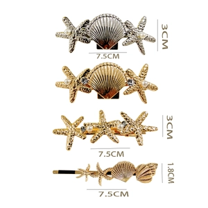 Detail view of starfish and seashell hair clips with pearl and rhinestone accents