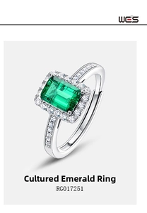 Macro shot of an emerald cut green lab-grown gemstone ring with diamond halo detail