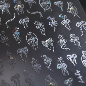 5D embossed nail stickers featuring white 3D bows and roses with iridescent rhinestones