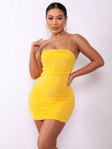 Detail of yellow bodycon mini dress with elegant ruching and spaghetti straps