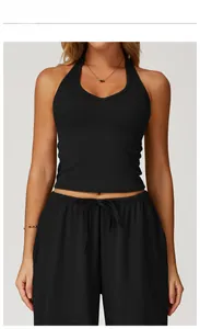Front view of black halter V-neck yoga tank top paired with matching drawstring sports pants