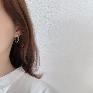 925 silver irregular water ripple gold hoop earrings worn by a model in minimalist style
