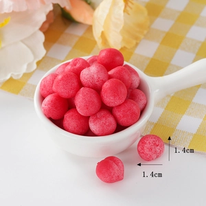 Miniature squishy TPR red peach toy in a white ceramic bowl showing 1.4cm diameter detail
