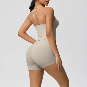 Detail of cross-strap back design on beige slim-fit yoga bodysuit for workout wear