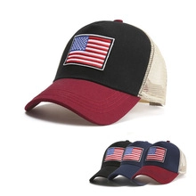 Detailed view of mesh trucker hats with American flag patches in various colors