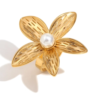 Vintage 18K gold plated plumeria flower ring with a white pearl on a clean white background