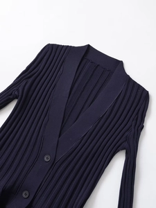 Close-up of deep blue ribbed knit cardigan featuring a V-neck and front buttons