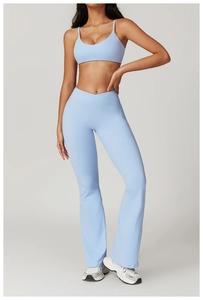 Detail of high-waist flared yoga leggings with crossover waistband in light blue