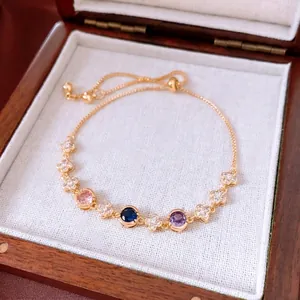 Adjustable 18k gold plated bracelet with flower charms and colorful gemstones