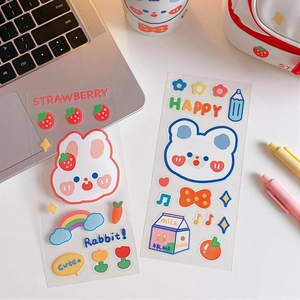 Cute cartoon bear and strawberry PVC stickers shown on a white organizer bag