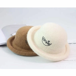 Close-up of wool blend hats with Smile embroidery in beige and brown colors