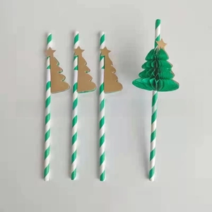 Detail of green 3D honeycomb Christmas tree and gold star on paper party straws