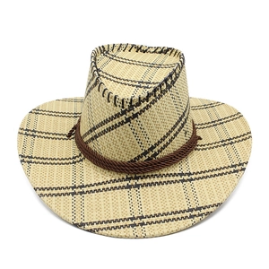 Detail of a straw western cowboy hat with a brown plaid pattern and twisted rope band