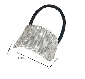 Detail view of 4.3cm silver metal hair tie with textured rectangular tree bark pattern