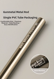 Detail of gunmetal nail brush with flower pattern engraving and PVC tube packaging