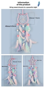 Detail of DIY dreamcatcher kit with pink moon, star, and cat charms with feathers