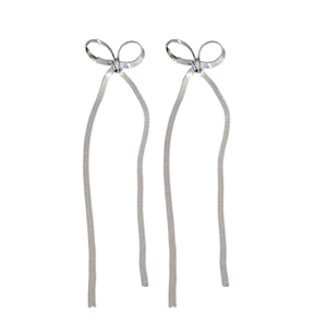 Minimalist silver metal chain earrings featuring delicate bow tie and snake chain tassels