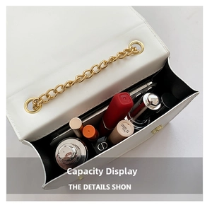 Detail view of white chain bag interior capacity holding phone and cosmetics