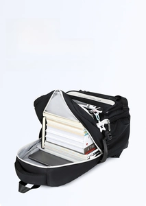 Macro view of large capacity black nylon backpack interior with books and tablet