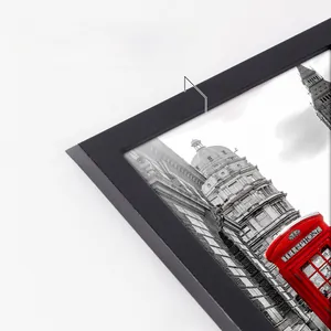 Detail of black wood picture frame showing 1.5cm width and sturdy frame corner texture