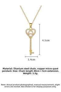 Close-up of gold heart key pendant featuring micro-pave stones and titanium steel chain