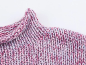 Macro view of pink and purple gradient starry sky yarn knit sweater ribbed neckline